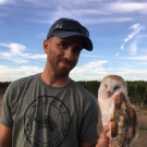 Ryan Bourbour with a Barn Owl in the field